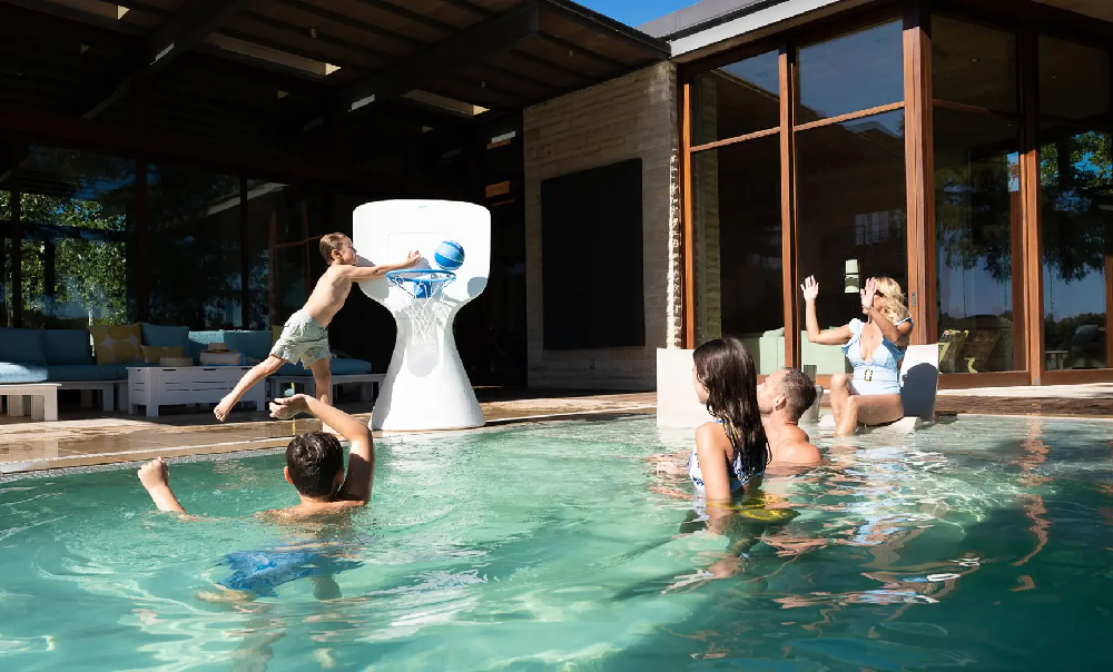 Luxury swimming pool with an in-pool basketball hoop creating a fun recreational amenity for family-friendly resorts and community pools.